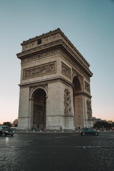 A stunning view of the Arc de Triomphe in Paris captured during the golden hour, highlighting its architectural beauty. One of My  Favorite Hidden Gems in Europe